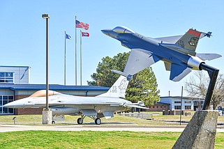 A retired F-16 of the Arkansas Air National Guard is seen near an F-16 statue, Friday, March 17, 2023, at the Ebbing Air National Guard Base in Fort Smith. The base is home to the Arkansas Air National Guards 188th Wing. Visit nwaonline.com/photo for today's photo gallery.
(River Valley Democrat-Gazette/Hank Layton)